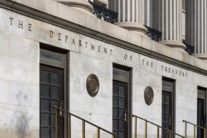 Staff reviewing unclaimed property files related to the escheatment unclaimed money process